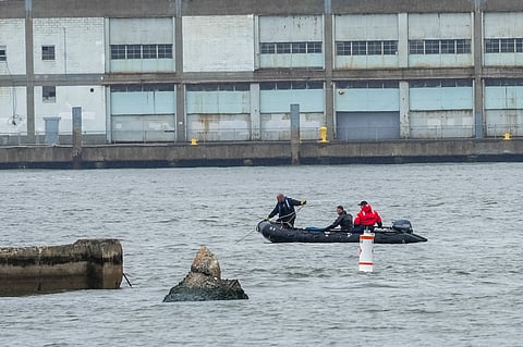 NYPD scuba divers team search next to the site of a crashed helicopter on the Hudson River on April 11, 2025 in Jersey City, New Jersey.