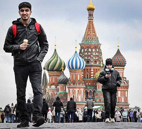 Tourists walk along Red Square in front of St. Basil's cathedral in downtown Moscow on April 11, 2025. Russian tourism officials described the Saudi market as one of the most promising emerging segments.