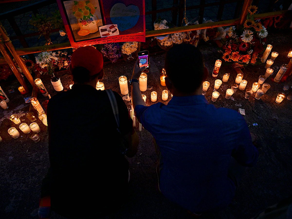 A couple light candles as friends and relatives pay tribute to the victims in front of the Jet Set nightclub in Santo Domingo.