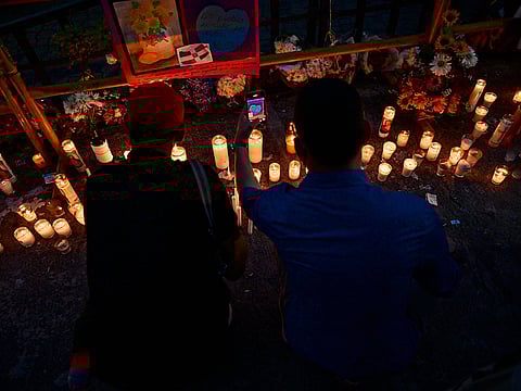 A couple light candles as friends and relatives pay tribute to the victims in front of the Jet Set nightclub in Santo Domingo.