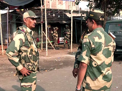 Security personnel stand guard after violent protests against the Waqf (Amendment) Act, at Dhuliyan in Murshidabad on Saturday, April 12, 2025. 