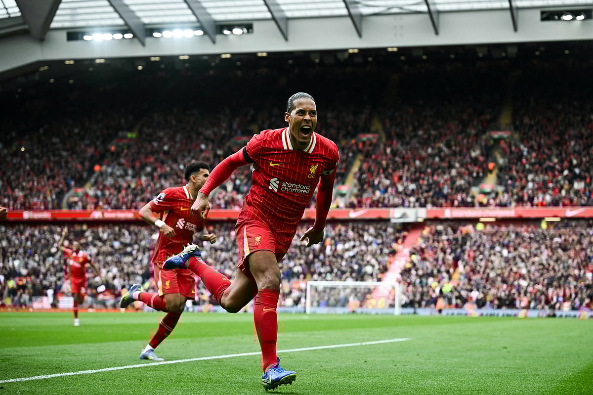 Liverpool's Dutch defender Virgil van Dijk celebrates after scoring his team second goal during the English Premier League football match against West Ham United at Anfield in Liverpool, north west England on April 13.