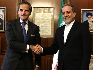 Iran’s Foreign Minister Abbas Araghchi (right) shakes hands with International Atomic Energy Agency (IAEA) Director General Rafael Mariano Grossi before a meeting in Tehran.  