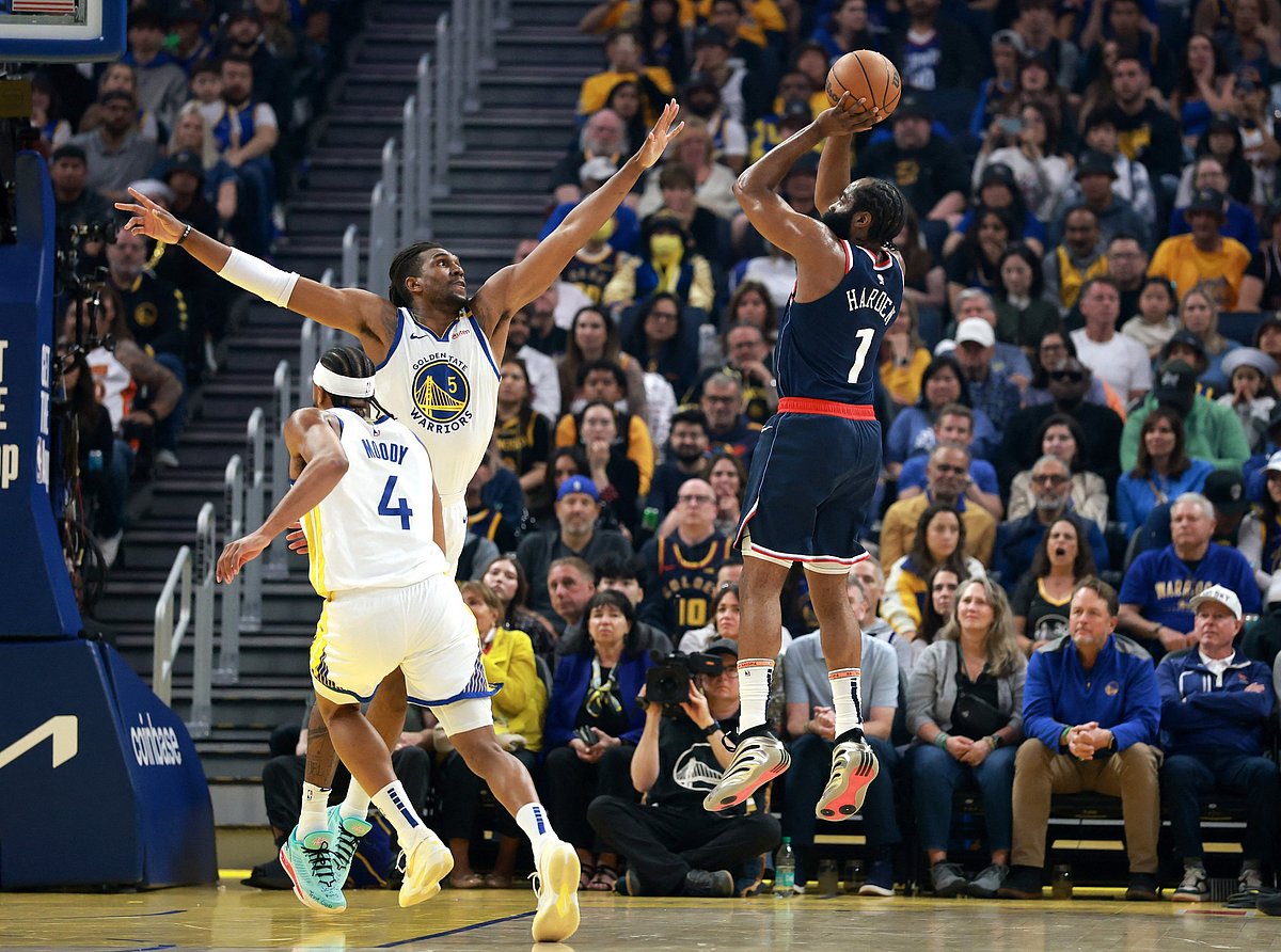 James Harden shoots over Kevon Looney of the Golden State Warriors.