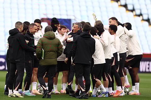 Paris Saint-Germain's Spanish headcoach Luis Enrique (C) and his players take part in a team training session at Villa Park in Birmingham, central England, on April 14.