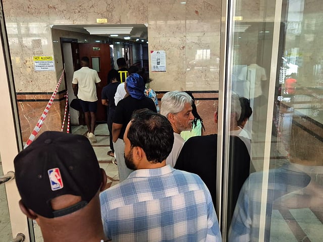 Residents queue up to enter the fire effected building in Al Nahda Sharjah. 