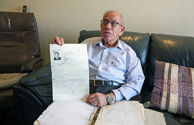 Muzavor Mohamed Sadiq shows old documents of his shop in Deira which he opened in 1973.