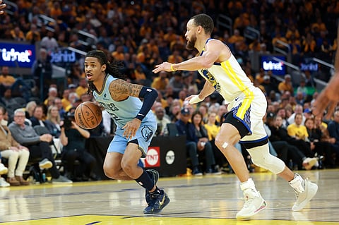 Ja Morant #12 of the Memphis Grizzlies is guarded by Stephen Curry #30 of the Golden State Warriors in the second half of the NBA play-in tournament game at Chase Center in San Francisco, California.