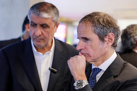 This handout picture made available by the Atomic Energy Organisation of Iran (AEOI) office shows the the head of the AEOI Mohammad Eslami (L) touring with the Director-General of the International Atomic Energy Agency (IAEA) Rafael Grossi (R) at the organisation headquarters in Tehran on April 17, 2025.