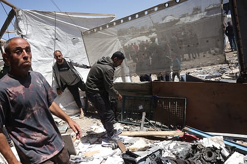 Palestinians inspect the damage after an Israeli strike on a school housing displaced Palestinians in Jabalia in the northern Gaza Strip on April 17, 2025.