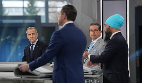 Canada's Liberal leader Mark Carney (L), Bloc Quebecois Leader Yves-Francois Blanchet (C) and Conservative Leader Pierre Poilievre (2nd L) listen to New Democratic Party Leader Jagmeet Singh (R) make a point during the French-language Federal Leaders' debate at Maison de Radio-Canada in Montreal, Quebec, Canada, on April 16, 2025.