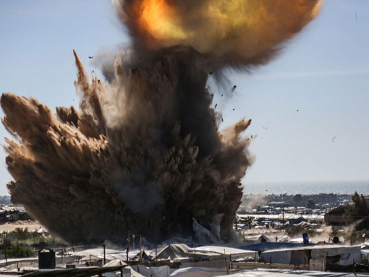 A plume of smoke and fire rises above tents at a camp for displaced Palestinians in northern Khan Yunis in the southern Gaza Strip, during an Israeli strike on April 19, 2025.