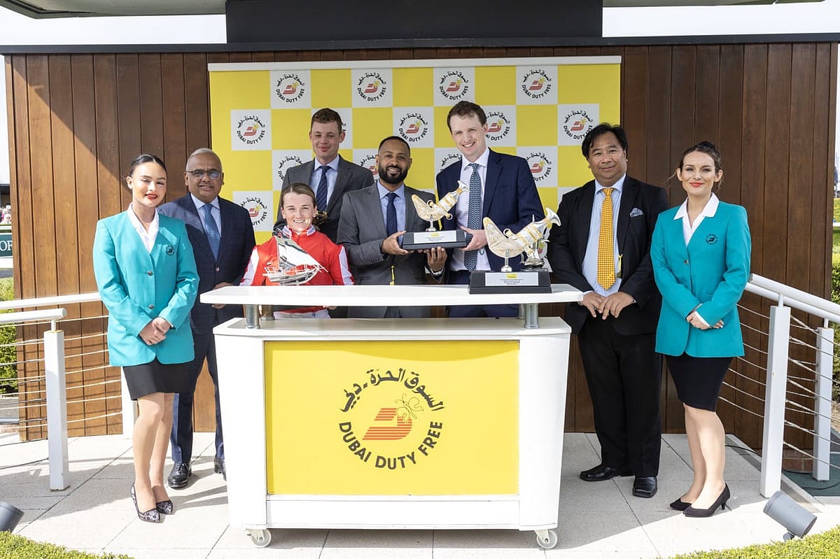 Ramesh Cidambi, owner’s representative Arthur Dobell, jockey Hollie Doyle and Noel Parial celebrate Duty First’s victory in the Group 3 Dubai Duty Free Stakes as trainer archie Watson receives his trophy from Salim Dahman.