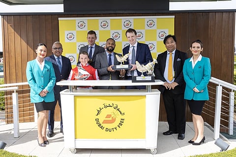 Ramesh Cidambi, owner’s representative Arthur Dobell, jockey Hollie Doyle and Noel Parial celebrate Duty First’s victory in the Group 3 Dubai Duty Free Stakes as trainer archie Watson receives his trophy from Salim Dahman.