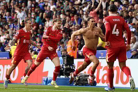 Liverpool's English defender Trent Alexander-Arnold (2R) celebrates after scoring the opening goal of the English Premier League football match against Leicester City at King Power Stadium in Leicester, central England on April 20.
