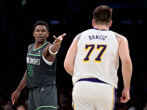 Anthony Edwards #5 of the Minnesota Timberwolves in front of Luka Doncic #77 of the Los Angeles Lakers.