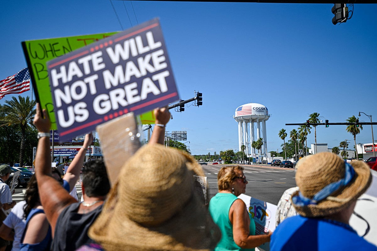 Demonstrators rally against Trump and join forces during a protest organized by the 50501 Movement on April 19, 2025, in Cocoa, Florida. 