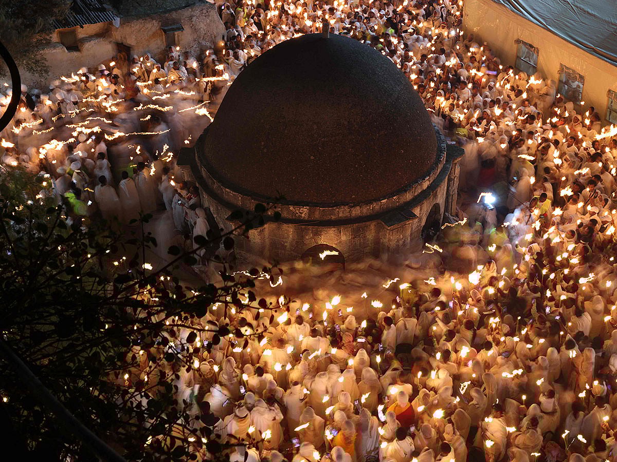 Ethiopian Orthodox Christian pilgrims hold candles during the ceremony of the "Holy Fire" at the Deir Al-Sultan Monastery on the roof of the Holy Sepulchre Church in Jerusalem's Old City on the eve of Orthodox Easter.