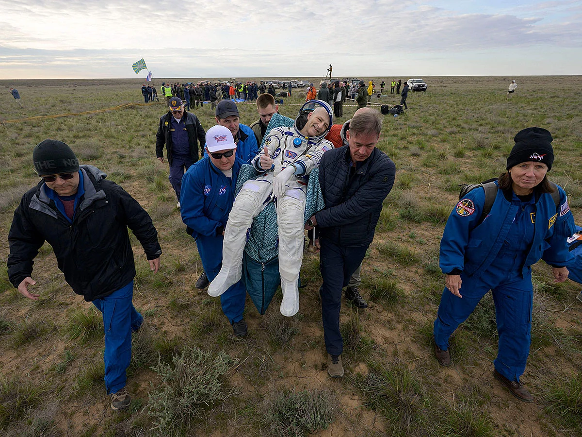 NASA astronaut Don Pettit (C)  being carried to a medical tent shortly after he, and Roscosmos cosmonauts Alexey Ovchinin and Ivan Vagner landed in their Soyuz MS-26 spacecraft near the town of Zhezkazgan, Kazakhstan.