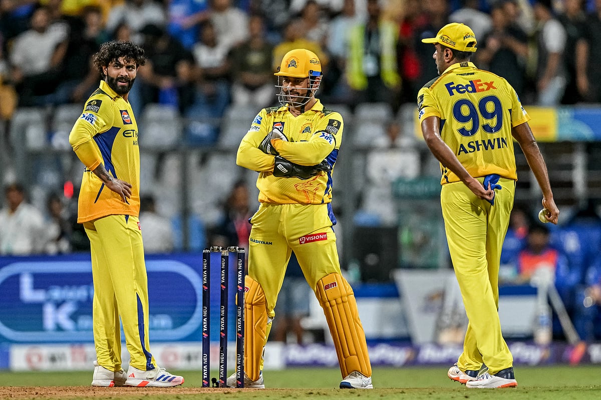 Chennai Super Kings' Ravindra Jadeja (left), Ravichandran Ashwin (right) and captain MS Dhoni discuss during the match against Mumbai Indians at the Wankhede Stadium.