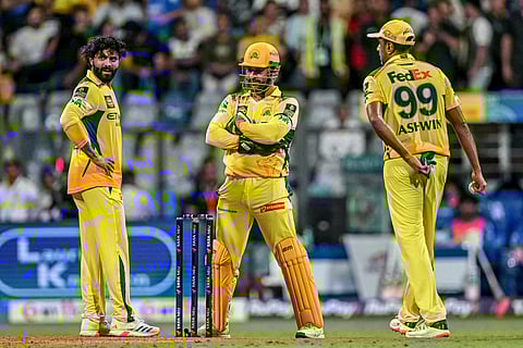 Chennai Super Kings' Ravindra Jadeja (left), Ravichandran Ashwin (right) and captain MS Dhoni discuss during the match against Mumbai Indians at the Wankhede Stadium.