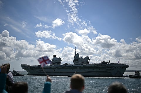 Members of the public gather to watch British aircraft carrier HMS Prince of Wales leave from Portsmouth Naval Base on the south coast of England. File photo taken on April 22, 2025.