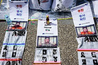 Pictures depicting North Korean leader Kim Jong Un are seen with anti-North Korea propaganda leaflets attached to bags at the Imjingak Pavilion near the Demilitarized Zone (DMZ) dividing the two Koreas in Paju, north of Seoul on April 23, 2025, as members of the Association of the Families of Those Abducted by North Korea prepare to send them across the border.