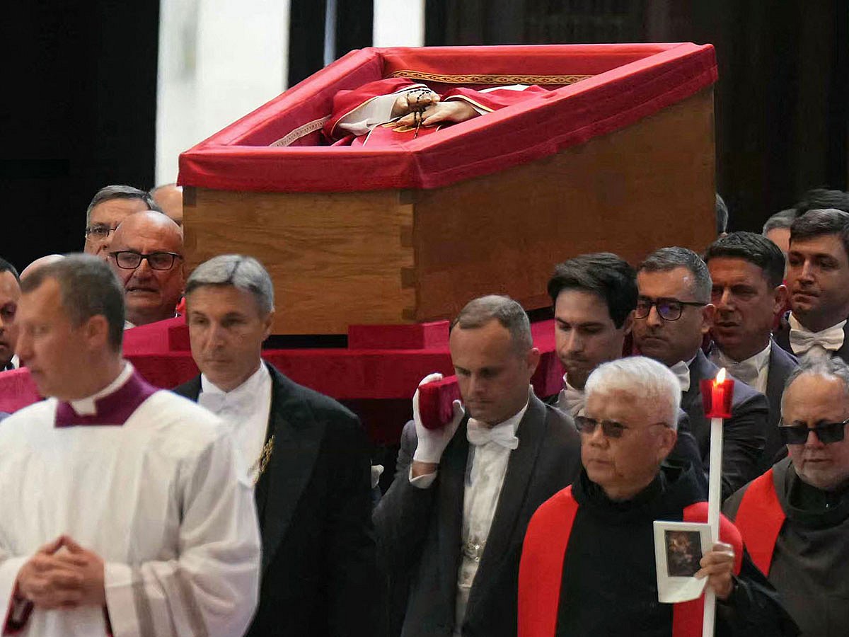 Pallbearers carry the coffin of the late Pope Francis inside St Peter's Basilica as it is transported in a procession from the chapel of Santa Marta to St Peter's Basilica.