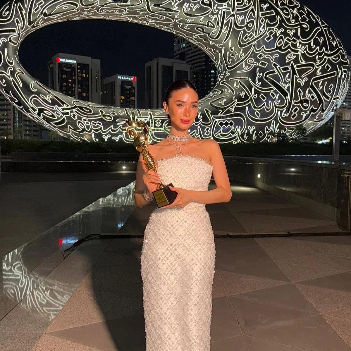 Heart poses with her trophy from EMI Gala against the backdrop of the Museum of the Future in Dubai.