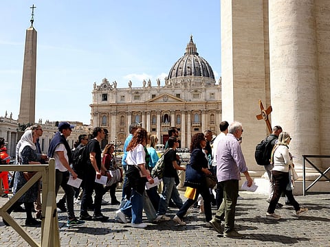 Visitors near the Saint Peter's Basilica on the day of Pope Francis' death in Vatican City.