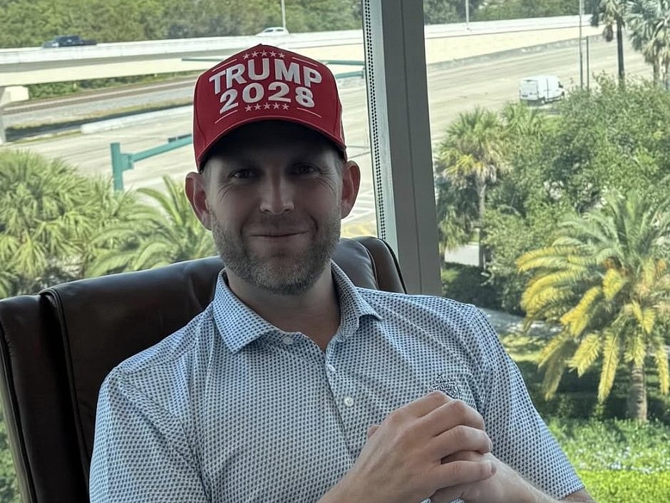 Eric Trump sporting one of the new red caps.