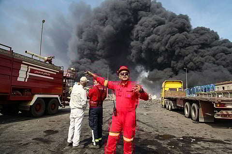 Thick, black smoke rises as rescuers arrive near the source of an explosion at the Shahid Rajaee port dock southwest of Bandar Abbas in the Iranian province of Hormozgan on April 26, 2025.