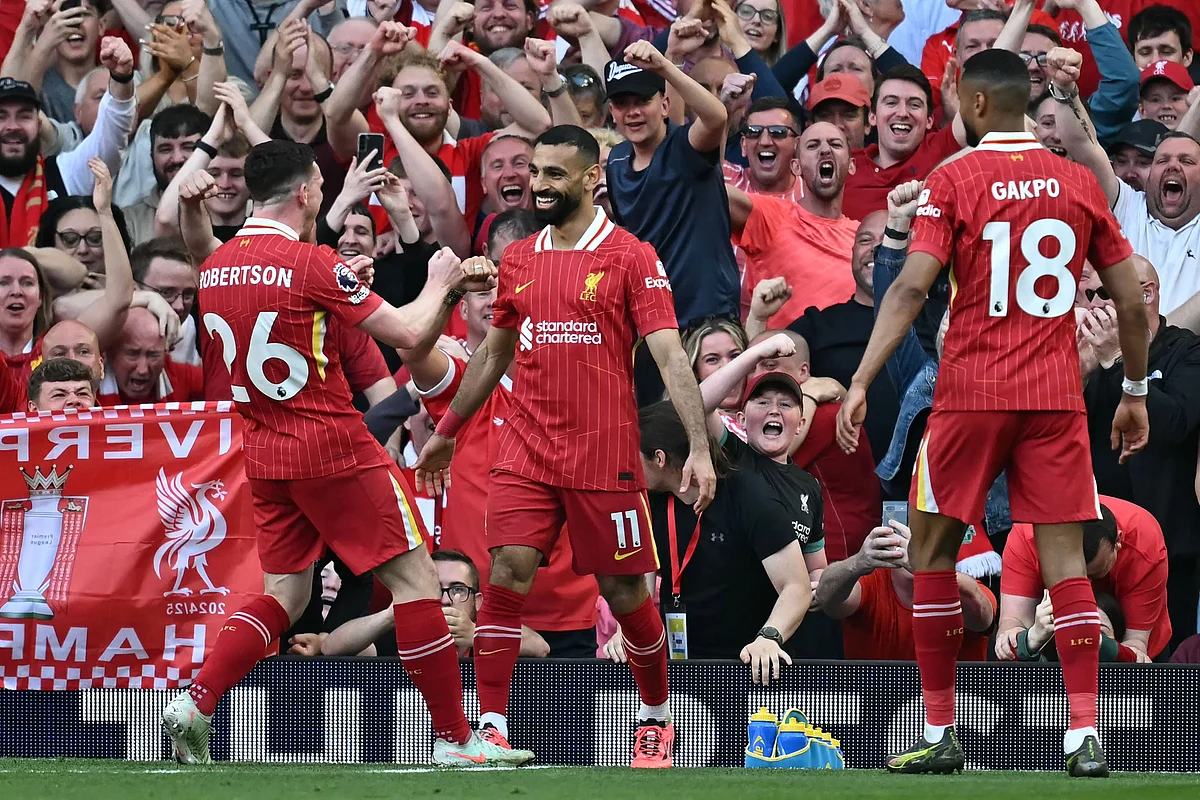 Liverpool's Egyptian striker #11 Mohamed Salah (C) celebrates with teammates after scoring their fourth goal during the English Premier League football match between Liverpool and Tottenham Hotspur at Anfield in Liverpool, north west England on April 27, 2025.