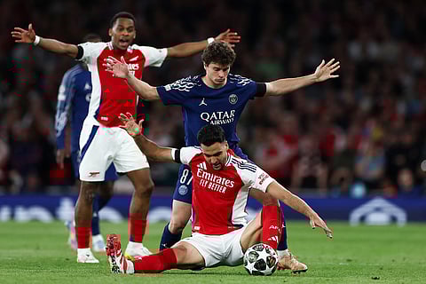 Arsenal's Spanish midfielder Mikel Merino (front C) and Paris Saint-Germain's Portuguese midfielder Joao Neves (rear C) react during the UEFA Champions League Semi-final First Leg football match at the Emirates Stadium in north London, on April 29.