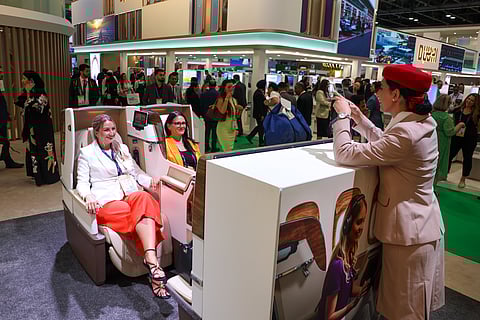 Visitors to the Emirates Pavilion during the Arabian Travel Market experience the comfort of Boeing 777 business class seats. 