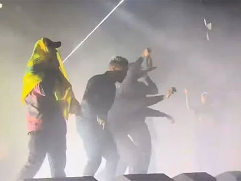 A Kneecap member wears a Hezbollah flag at a concert in London. In its denial issued late on Monday, Kneecap said video footage had been “deliberately taken out of context.