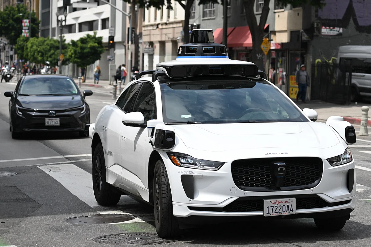 A Waymo autonomous self-driving Jaguar electric vehicle drives in downtown Los Angeles, California on May 1, 2025.