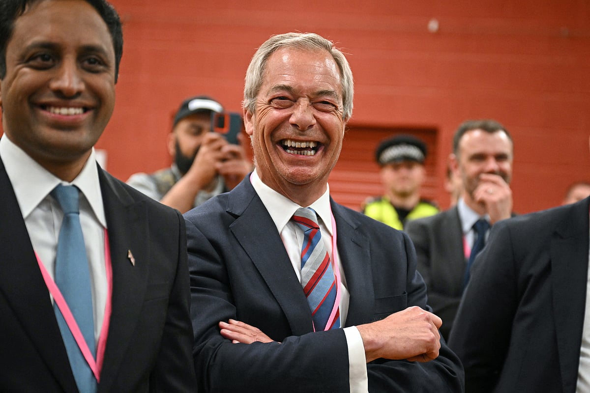 Nigel Farage (C), leader of the Reform UK party, celebrates the victory of Sarah Pochin, the party’s candidate, in the Runcorn & Helsby by-election at the DCBL Stadium in Widnes, north-west England, in the early hours of May 2, 2025.