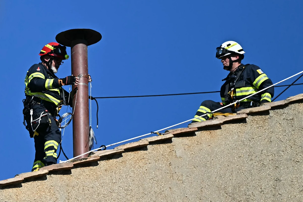 Workers install the chimney on the roof of the Sistine Chapel in The Vatican, on May 2, 2025.