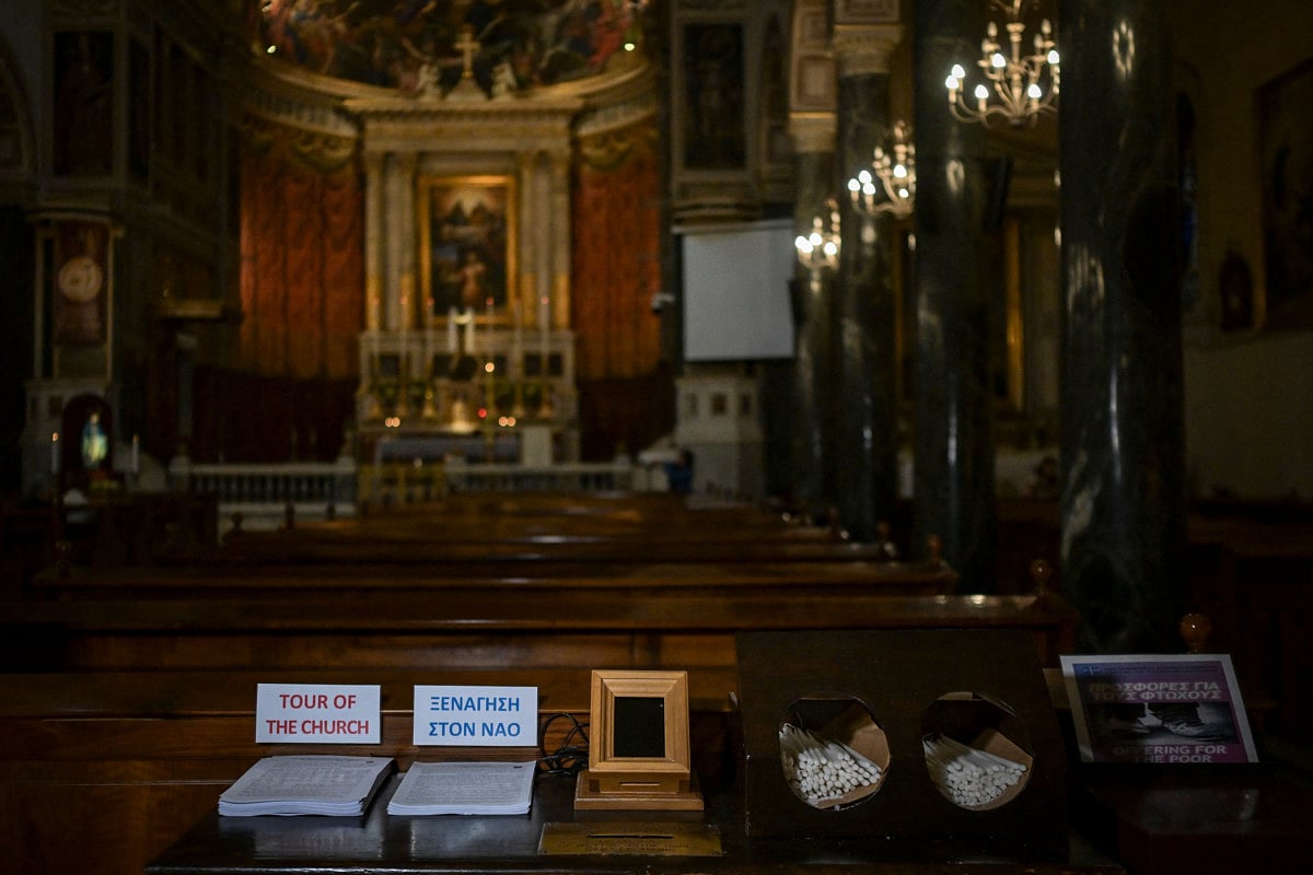 A Point of Sale (POS) device (bottom C) is pictured at the Catholic Church of St Dionysius the Areopagite in Athens on May 4, 2025.  