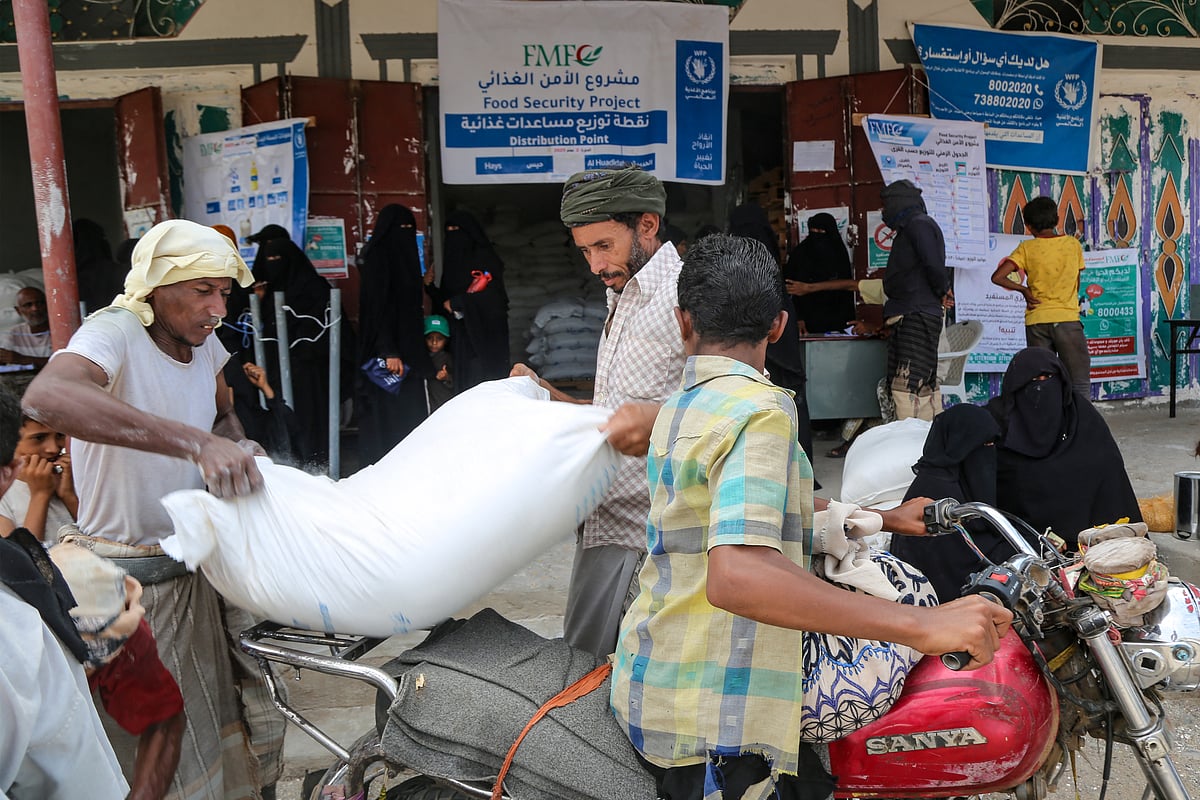 Displaced Yemenis load bags of food and supplies to meet their basic needs on their motorcycle in the western province of Hodeida on May 4, 2025.