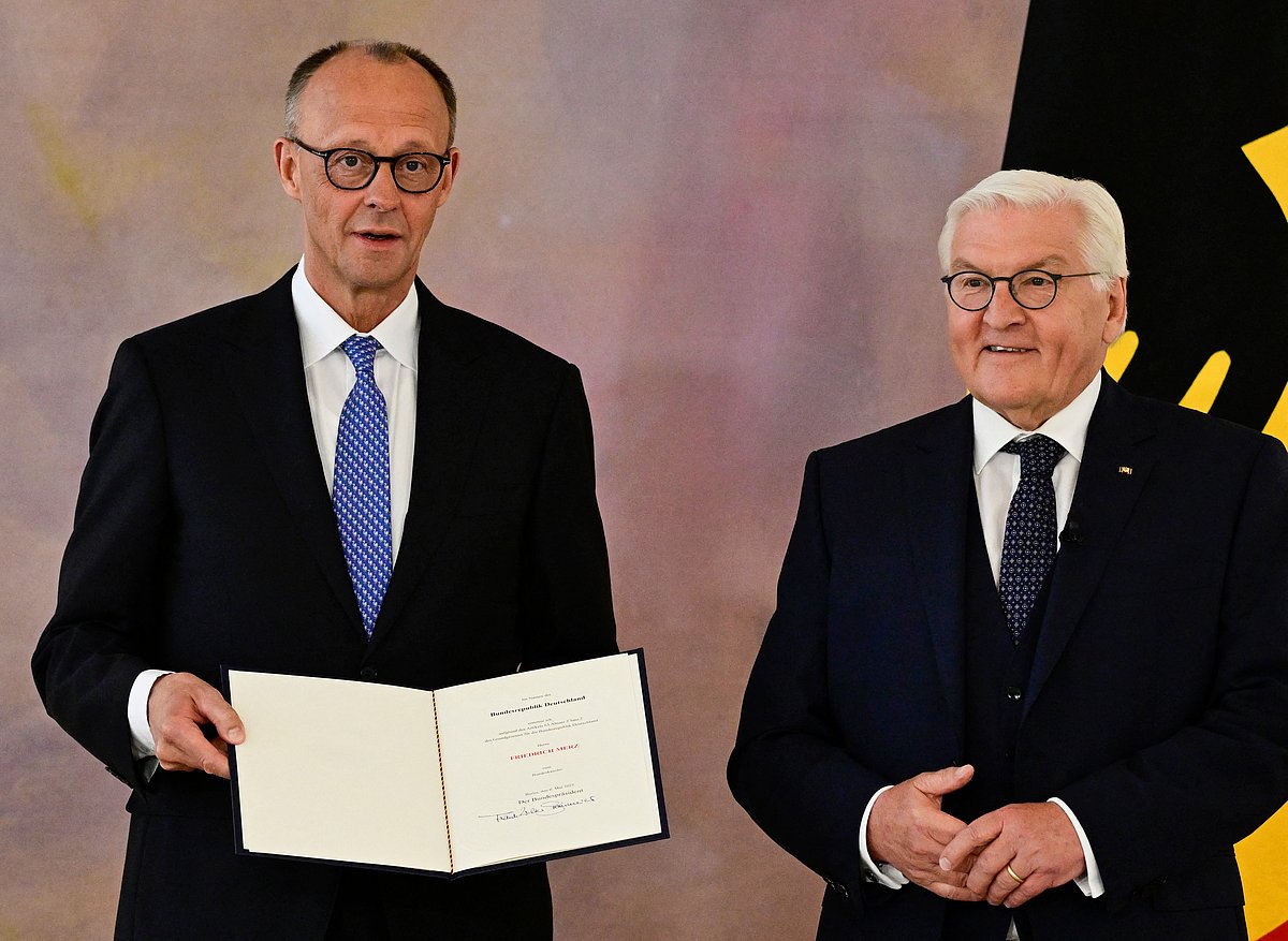 Friedrich Merz (left) receives his certificate of appointment from German President Frank-Walter Steinmeier after he was elected as Germany's new Chancellor, at the presidential Bellevue Palace in Berlin on May 6, 2025.
