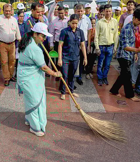 Delhi Chief Minister Rekha Gupta takes part in the cleanliness campaign organised by NDMC, on Pracheen Hanuman Temple complex in New Delhi on Tuesday.  