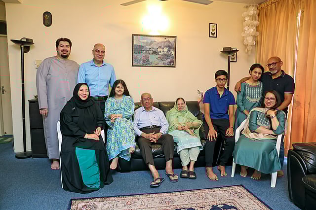 Muzavor Mohamed Sadiq and wife Rukaiyabi Muzavor pose for a family picture with their daughters, sons-in law and grandchildren before vacating their apartment in Al Shaab Colony in Deira, which was their home for 48 years.