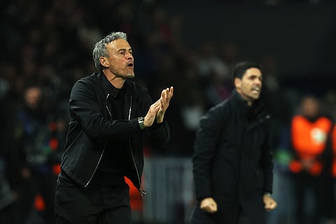 Paris Saint-Germain's Spanish coach Luis Enrique (L) reacts next to Arsenal's Spanish coach Mikel Arteta (R) during the UEFA Champions League semi-final second leg football match, on May 7, 2025.
