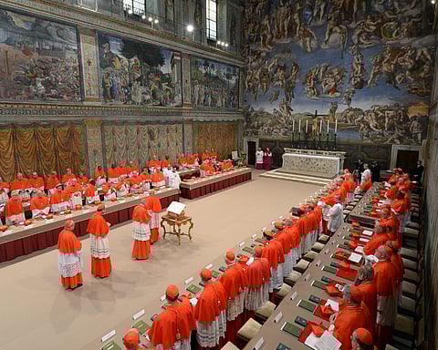 A handout picture released by the Vatican Press office shows cardinals queuing in the Sistine Chapel before the start of the conclave at the Vatican on March 12, 2013.