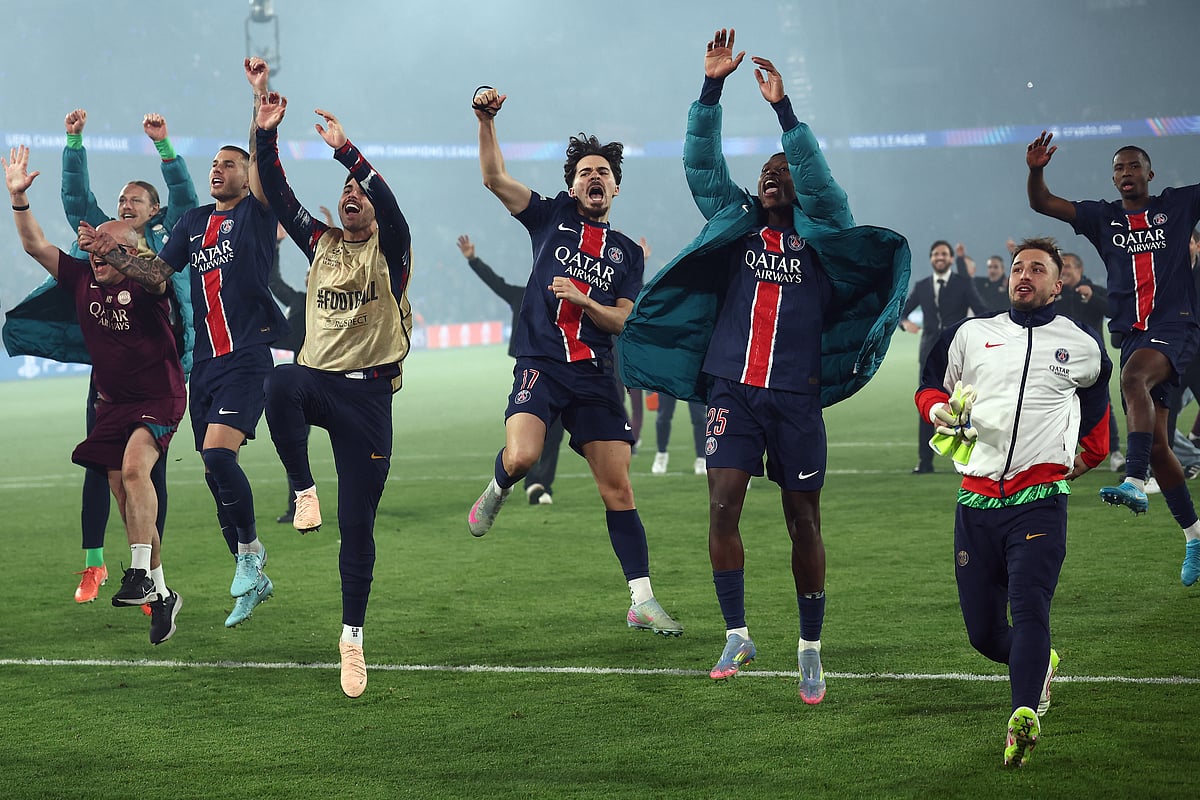 PSG's players celebrate their victory at the end of the Uefa Champions League semi-final second leg football match against Arsenal at the Parc des Princes stadium in Paris, on May 7.