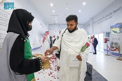 A foreign pilgrim is being welcomed upon arriving in Saudi Arabia to perform the annual Hajj pilgrimage. 