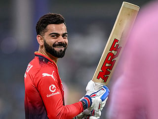 Virat Kohli shares a light-hearted moment on the field during an IPL match for RCB.