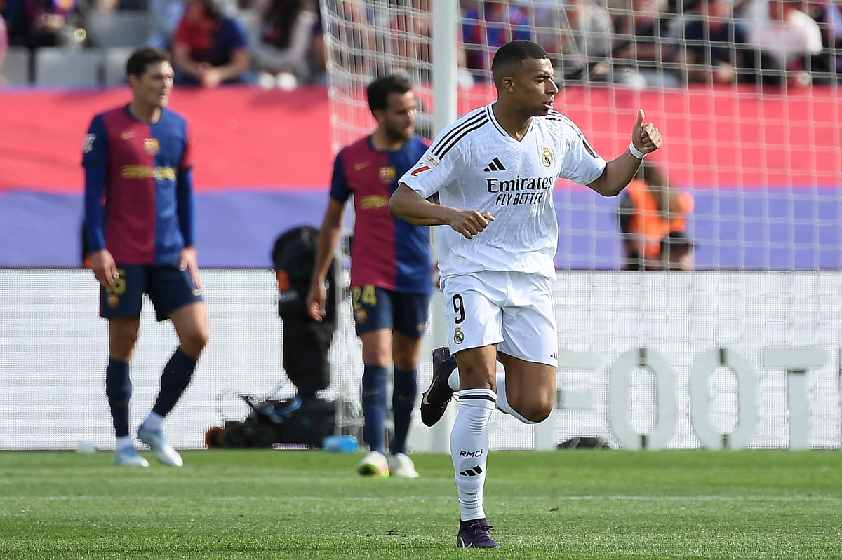 Real Madrid's French forward Kylian Mbappe celebrates scoring his hat-trick during the Spanish league football match against FC Barcelona at Estadi Olimpic Lluis Companys in Barcelona, on May 11.